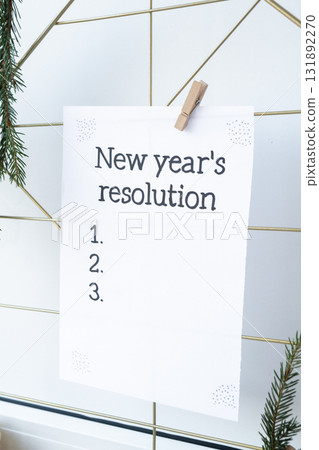 Action board NEW YEAR'S RESOLUTION on paper note. Making promises for new year, setting goals. Dream year 131892270