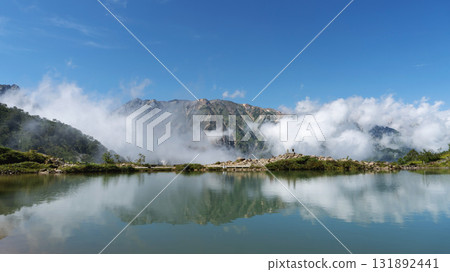 Mountains and clouds reflected in the deserted Happo Pond [Happo Ridge] Hakuba Village, Nagano Prefecture, September 131892441
