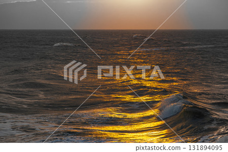 The tranquility and grandeur of the coastline in the golden afterglow 131894095