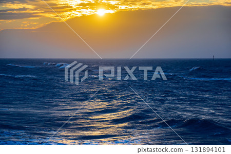 The tranquility and grandeur of the coastline in the golden afterglow 131894101