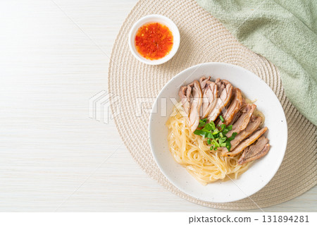 dried noodles with stewed duck in white bowl 131894281
