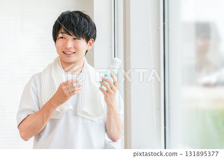 A young Asian man taking care of his bad breath by using mouthwash in the morning A young Asian man taking care of his bad breath by using mouthwash in the morning 131895377