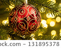 Red Christmas Ornament with Golden Pattern on Tree 131895378