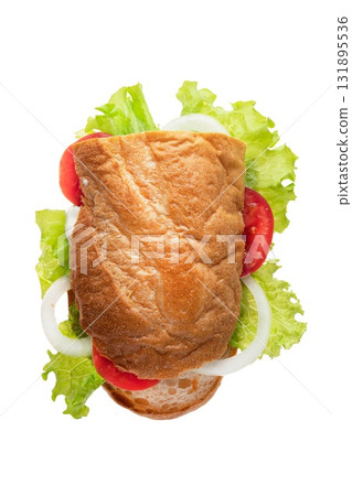 Fresh sandwich with lettuce, tomato, and onion on a soft bread bun arranged on a clean surface Fresh sandwich with lettuce, tomato, and onion on a soft bread bun arranged on a clean surface 131895536