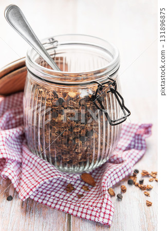 Homemade granola cereal with chocolate chips in jar Homemade granola cereal with chocolate chips in jar 131896875
