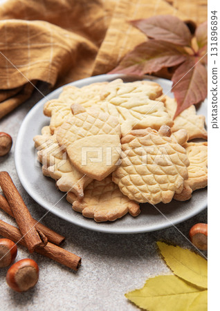 Autumn cookies on plate with cinnamon and hazelnuts Autumn cookies on plate with cinnamon and hazelnuts 131896894