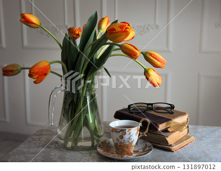 Classic still-life with books and tulips and a cup of tea Classic still-life with books and tulips and a cup of tea 131897012