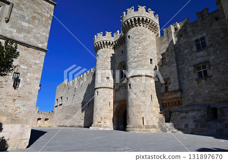 Beautiful old town of Rhodes on the Greek island of Rhodes. Beautiful historical architecture with castle, shops and cafes. Concept for travel and vacation. Beautiful old town of Rhodes on the Greek island of Rhodes. Beautiful historical architecture with castle, shops and cafes. Concept for travel and vacation. 131897670