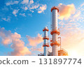 Modern Industrial Chimneys Against Beautiful Blue Sky with Soft Clouds and Warm Sunset Light 131897774