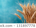 Golden Wheat Stalks Against a Soft Blue Background in a Serene Natural Setting 131897778