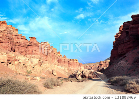 Famous landmark Natural monument Valley of Castles, National Nature Park, Almaty region, Kazakhstan. Picturesque scenery of Charyn Canyon in the sunset light, northern region of Tien Shan Mountains Famous landmark Natural monument Valley of Castles, National Nature Park, Almaty region, Kazakhstan. Picturesque scenery of Charyn Canyon in the sunset light, northern region of Tien Shan Mountains 131898469