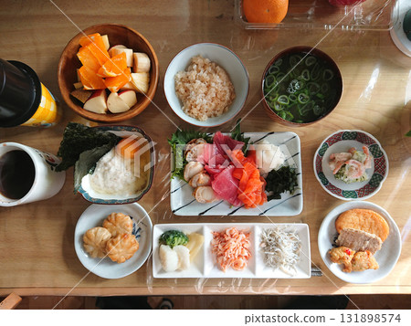 A typical Japanese menu: A Japanese meal consisting of a platter of three types of sashimi as a main dish, along with appetizers and small side dishes. 131898574
