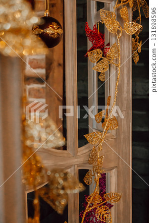 decorative golden ornaments and plants adorn wooden display in festive setting. closeup. decorative golden ornaments and plants adorn wooden display in festive setting. closeup. 131898596