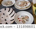 colorful cookies and decorative plates displayed on kitchen table in cozy home setting. closeup. 131898601