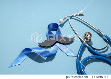 Blue ribbon, paper mustache, and stethoscope raise awareness Blue ribbon, paper mustache, and stethoscope raise awareness 131898914