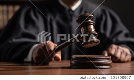 Gavel in hand for courtroom decision. Symbol of authority, justice, and law. Sound of order in court. Impartiality. 131898967