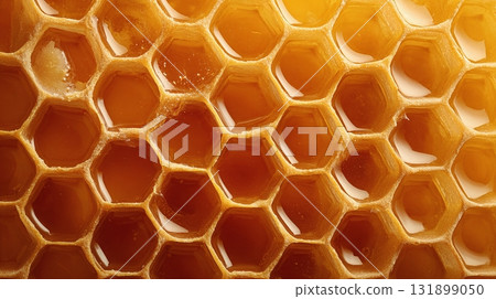 Honeycomb: A mesmerizing macro shot of hexagonal cells filled with golden liquid, highlighting nature's perfect architecture and delicious treat. Honeycomb: A mesmerizing macro shot of hexagonal cells filled with golden liquid, highlighting nature's perfect architecture and delicious treat. 131899050