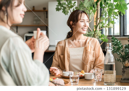 A woman eating a delicious lunch with her female friends (girls' gathering) 131899129