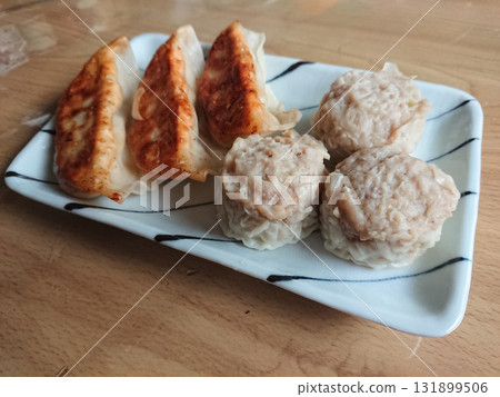 Dim Sum / Dim Sum - A plate of pan-fried dumplings and shumai (weekend Chinese lunchtime) Dim Sum / Dim Sum - A plate of pan-fried dumplings and shumai (weekend Chinese lunchtime) 131899506