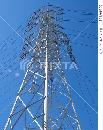 High voltage tower and the clear sky High voltage current tower shining against the blue sky 131899602