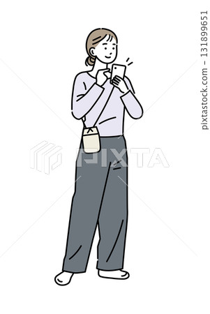 A woman holding and operating a mobile phone 131899651