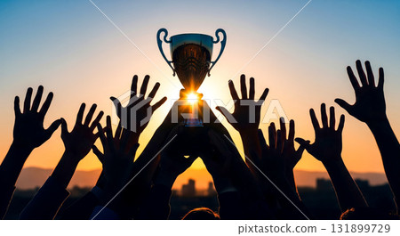 Silhouette of many hands reaching for trophy at sunset, team success and victory concept, people celebrating sport championship win with award together 131899729