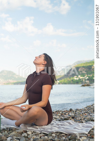 Relaxing by the sea following psychologist advice meditation restoring mental balance and harmony outdoors 131901067