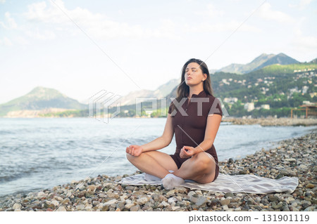 Morning yoga by the sea calmness harmony and connection with nature promoting wellness and relaxation Morning yoga by the sea calmness harmony and connection with nature promoting wellness and relaxation 131901119
