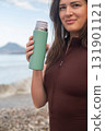 Active outdoor fitness on the coast staying hydrated recovery and wellness healthy lifestyle by the sea 131901121