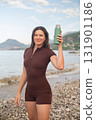 Morning workout by the sea woman drinking water fitness wellness and coastal active lifestyle outdoors 131901186
