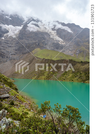 Emerald waters of Laguna Humantay surrounded by Andean mountains in Peru 131901723