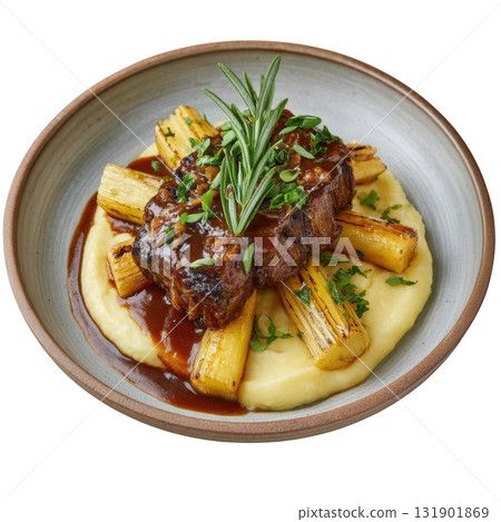 Braised Veal Cheek with Madeira Glaze and Smoked Celery Root Mash On a Plate Garnished with Fresh Herbs 131901869