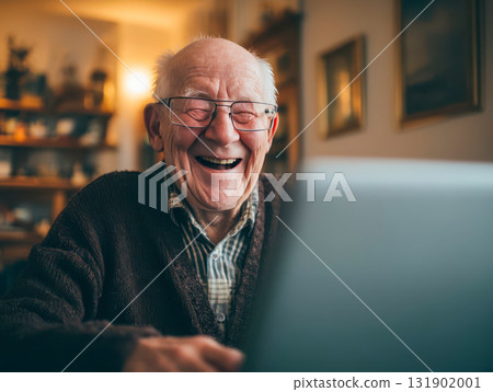 Happy senior man laughing during video call on laptop, concept of senior lifestyle and connection with technology 131902001