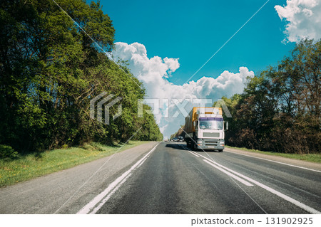 Truck On Country Road. Tractor Unit, Prime Mover, Traction Unit In Motion On Countryside Road In Europe. Business Transportation And Trucking Industry Concept Truck On Country Road. Tractor Unit, Prime Mover, Traction Unit In Motion On Countryside Road In Europe. Business Transportation And Trucking Industry Concept 131902925