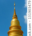 Golden Pagoda Stupa Against Blue Sky in Thailand 131903479
