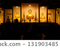 Golden Buddha Statue Illuminated at Night in Thai Temple 131903485