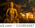Fasting Buddha Statue under Tree at Night in Thai Temple 131903487