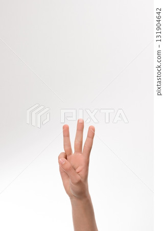 Close-up of a hand showing the number three against a white background. Perfect for counting, education, or number representation. 131904642