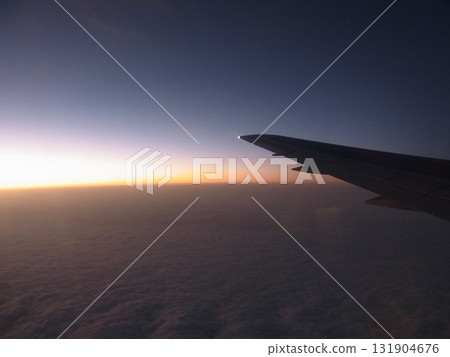 Sunset view during flight over the wing of an aircraft Sunset view during flight over the wing of an aircraft 131904676