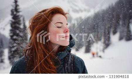 A red-haired woman stands serenely in a snowy landscape, eyes closed, enjoying the winter atmosphere and fresh air. Serene moment in the snow. A red-haired woman stands serenely in a snowy landscape, eyes closed, enjoying the winter atmosphere and fresh air. Serene moment in the snow. 131904818
