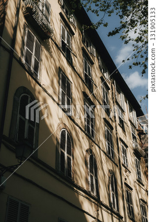 Sunlit Facade of Historic Building Displaying Shadows 131905133