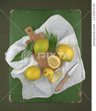 Still life in the technique of painting with lemon and slices on a vintage green wooden table on a black background as banner or wall picture 131905330