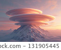 Ethereal Lenticular Clouds Floating Above a Snowy Mountain Peak 131905445