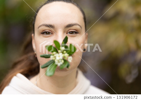 Woman holding flowers expressing connection with nature Woman holding flowers expressing connection with nature 131906172