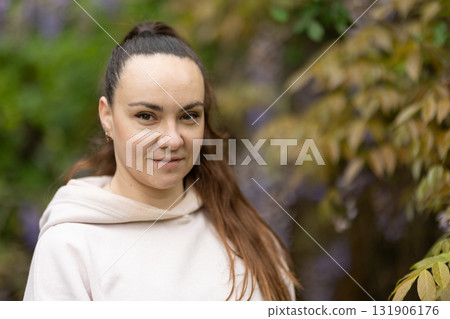 Young woman smiling outdoors in nature setting 131906176