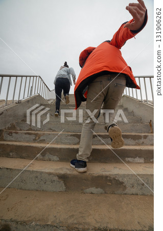 People climbing concrete stairs reaching for success People climbing concrete stairs reaching for success 131906262