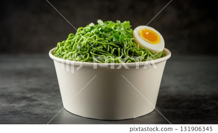 Gluten free green noodles with egg on blank white paper bowl dark  background 131906345