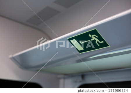 Train emergency exit sign, highlighting the safety measures in place for passengers. It emphasizes evacuation procedures, ensuring safe journey for everyone on board Train emergency exit sign, highlighting the safety measures in place for passengers. It emphasizes evacuation procedures, ensuring safe journey for everyone on board 131906524