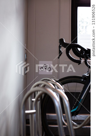 Bicycle rack in train carriage, with clear bike symbol indicating designated area for bicycles. Ideal for promoting cycling travel or eco friendly transport options within public transportation 131906526