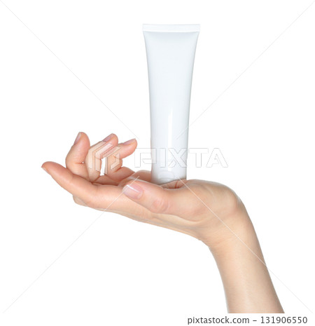 Hand holding white blank cosmetic cream tube isolated on transparent background 131906550